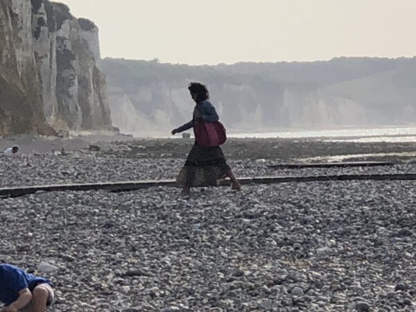 Einsame Frau am Steilküsten-Kiesstrand in Nordspanien